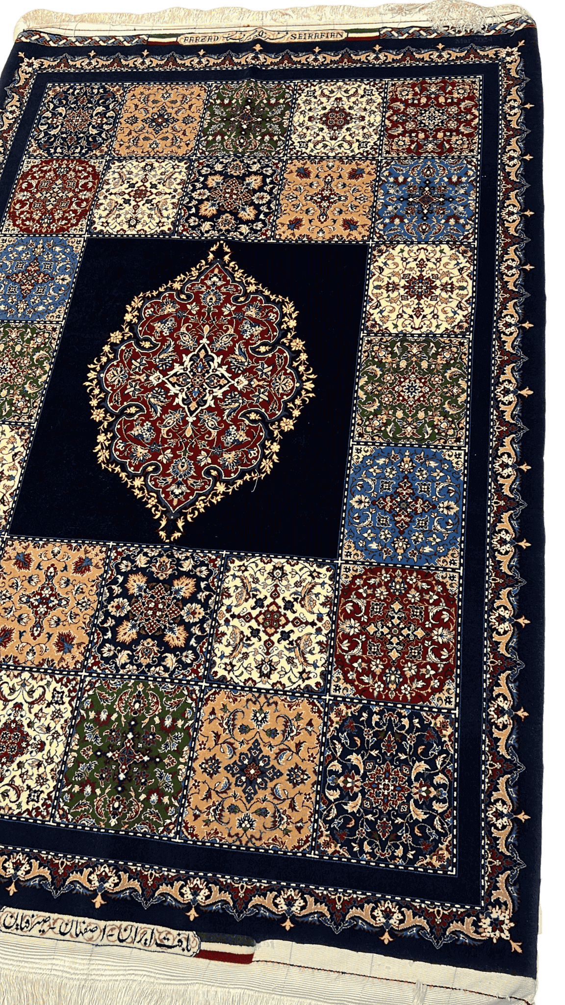 "Angled view of a hand-knotted Farzad Seirafian Persian rug showcasing the detailed mosaic pattern and medallion in rich colors, made from silk and wool."